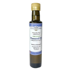 Bottle of organic flaxseed oil with a white label on a white background