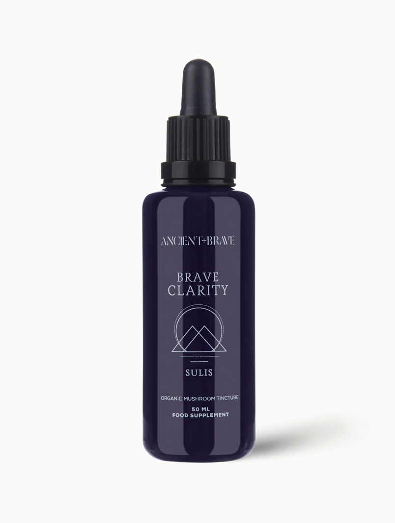 Purple bottle labeled &#39;Brave Clarity&#39; on a white background