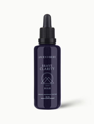 Purple bottle labeled 'Brave Clarity' on a white background