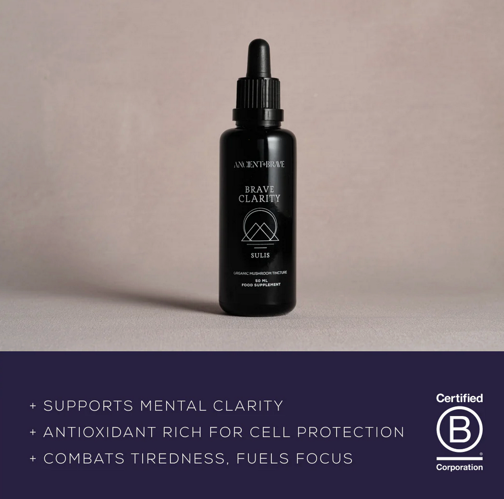 Black bottle with dropper labeled &#39;Brave Clarity&#39; on a beige background, featuring certification logo.