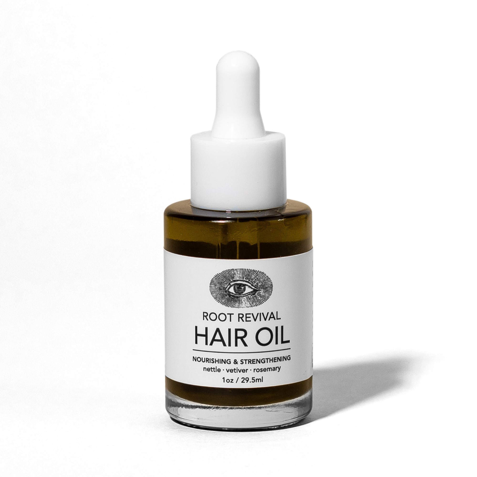 Hair oil bottle with dropper labeled &#39;Root Revival Hair Oil&#39; on a white background