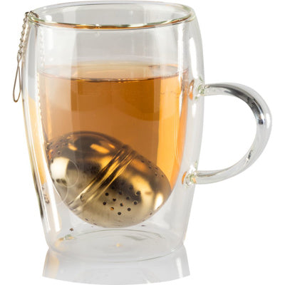 Clear glass mug with tea infuser and tea inside on a white background
