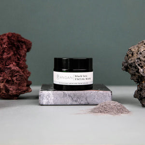 A jar of ANGAN Black Lava Facial Mask, with a label that includes the brand name and product description, against a white background.