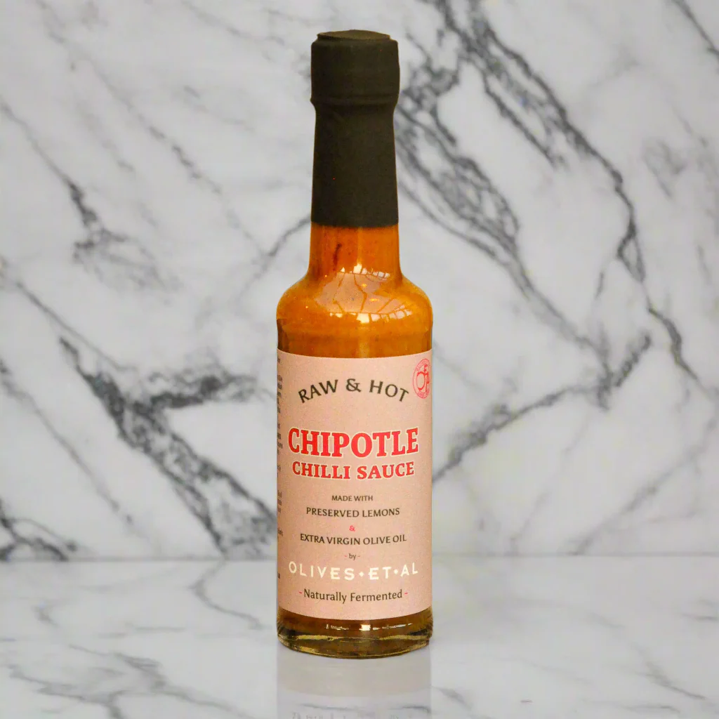 Bottle of chipotle chili sauce on a marble background