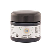 A black jar labeled 'Raw Living Mountain Shilajit Resin' with a white and green label, indicating the product is 40g in size and sourced from the Altai Mountains.