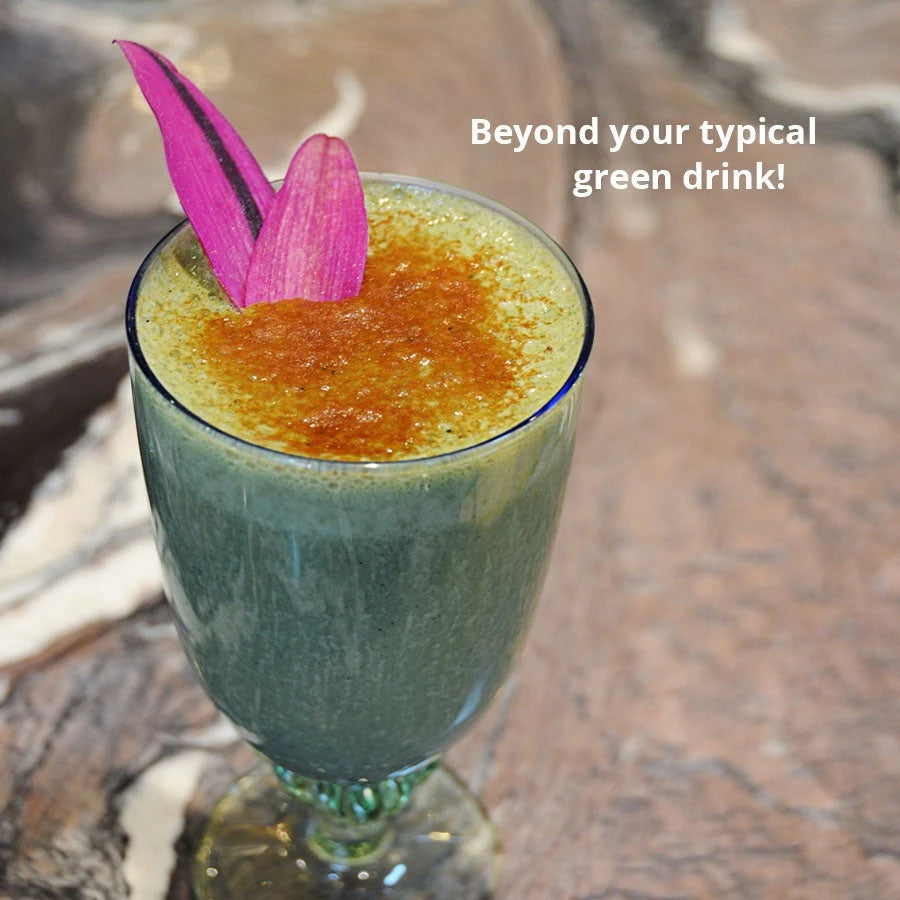 Serving suggestion: a green Dragon Herbs Tonic Alchemy smoothie in a glass, topped with a pink flower