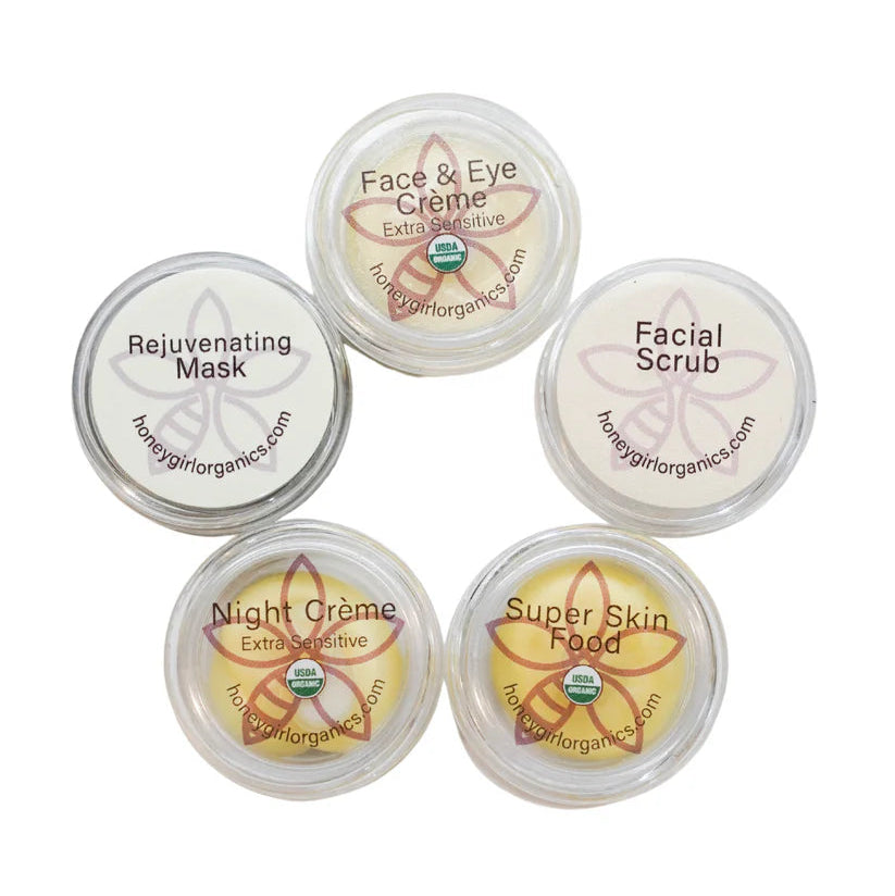 Set of five Honey Girl Organics skincare sample products on a white background