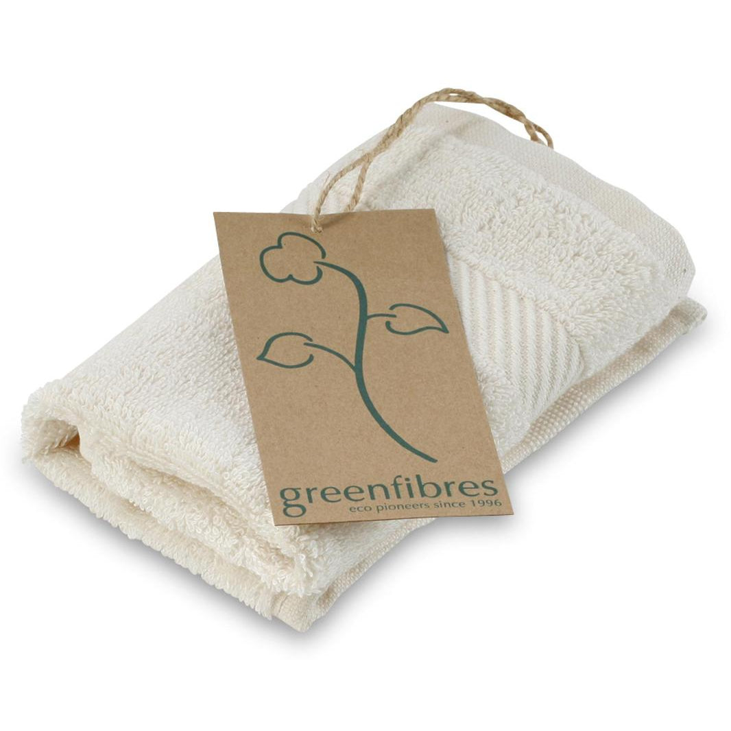 Folded beige towel with a 'greenfibres' tag on a white background