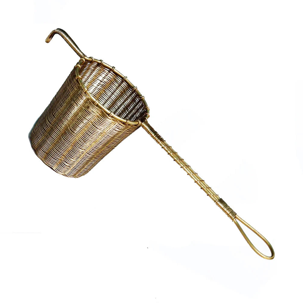 Brass strainer with handle on a white background